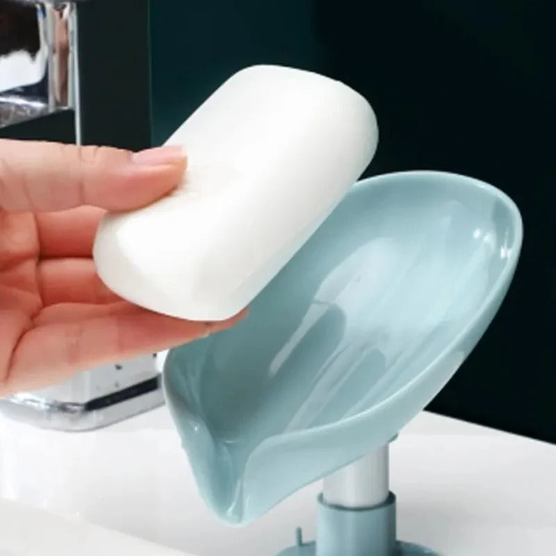 Leaf shaped self draining soap holder with suction base